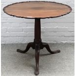 An 18th century later carved mahogany pie-crust snap top tripod table, 81cm diameter x 71cm high.