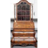 A late 18th century Dutch marquetry inlaid bonnet top bureau bookcase, with bomb three drawer base,