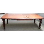 An early Victorian mahogany extending dining table, on reed and fluted supports, two extra leaves,