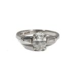 A platinum and diamond single-stone ring, the oval-cut diamond measuring 1.