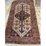 A Hamadan rug, Persian, the ivory field with a diamond medallion; all with a stylised herate design,