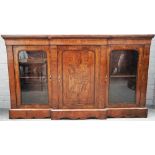 A Victorian figured walnut breakfront three door side cabinet on plinth base,