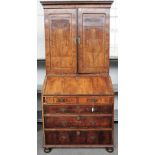 A George II walnut cross and feather banded bureau cabinet,