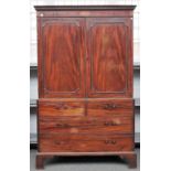 A George III mahogany linen press, the pair of panel doors over two short and two long drawers,