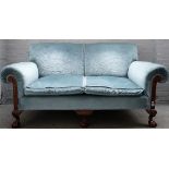A Chippendale revival roll arm sofa with carved mahogany frame, on claw and ball feet,