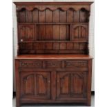 An 18th century style fruitwood dresser, the enclosed two tier plate rack, with a pair of cupboards,