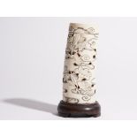 A Japanese ivory tusk vase, Meiji period, pierced and carved with a bird amongst flowers, 14.5cm.