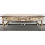 A George III plank top pine preparation table, on painted two drawer base with block supports,
