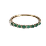 A cabochon emerald and diamond-set gold oval hinged bangle,