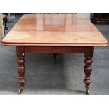 A 19th century mahogany extending dining table, on turned supports with two extra leaves,