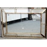 A 20th century cushion framed segmented mirror, 83cm wide x 57cm high,