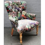 A Victorian style button back armchair, upholstered in Birds' of Paradise fabric,