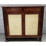 A Regency mahogany side cabinet with a pair of drawers over grille doors, on carved paw feet,