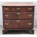 A mid-18th century red walnut chest, of three short over two long graduated drawers,