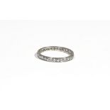 A diamond-set eternity ring, claw-set with circular-cut diamonds, ring size L, 1.8g gross.