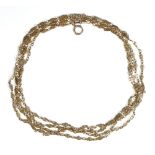 A gold long guard muff chain, in a pierced oval and circular link design,