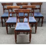 A set of six George III mahogany dining chairs, with carved waist rail on reeded supports,