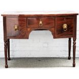 A late George III mahogany bowfront sideboard, with three frieze drawers on turned supports,