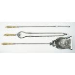 A set of Victorian polished steel fire irons, with brass handles, and a pierced shovel plate, 78cm,