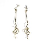 A pair of 18ct gold pendant earrings, of elongated scrolled design, the tops with post fittings,