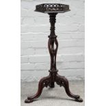 A mid-18th century style mahogany jardiniere stand with fret pierced hexagonal top and carved