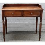 A Regency mahogany galleried two drawer writing table, on turned supports, 91cm wide x 83cm high.