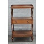 A Victorian walnut three tier what-not, with single drawer on barleytwist supports,