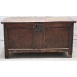 A 17th century oak coffer, with plank top over double panel front, 118cm wide x 61cm high.