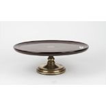 A mahogany and brass Lazy Susan with dished top and turned base, 42cm diameter x 14cm high.