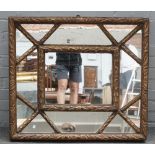 A 20th century gilt framed wall mirror, with segmented concave frame, 89cm wide x 77cm high.