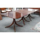 A Regency style mahogany four pillar extending dining table on downswept supports,