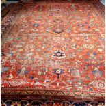 A Mahal carpet, Persian, the madder field with an allover design of bold flowerheads,