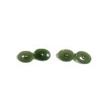 A pair of nephrite cufflinks, having oval backs and fronts.