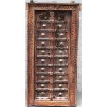A 19th century Eastern carved hardwood window, with double arch panel doors, 61cm x 119cm high.