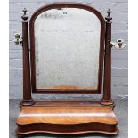 A large Victorian mahogany toilet mirror, with serpentine lift top base, 68cm wide x 86cm high.