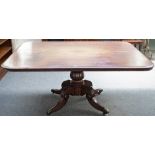 A late George III mahogany rectangular snap top breakfast table on four scroll supports,