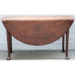 A George II mahogany oval drop flap dining table, on pad feet, 131cm wide x 73cm high.