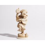 A Japanese ivory okimono of Daikoku, Meiji period, carved standing holding a mallet,