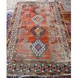 A Kazakh rug, Caucasian, the madder field with four hooked diamonds,