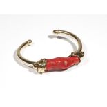 A gold and coral bangle, the front mounted with a section of branch coral (restored), detailed 750,