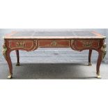 In the manner of Charles Crescent, a Louis XV style gilt metal mounted kingwood bureau plat,