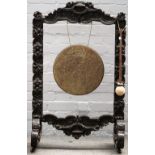 A Victorian dinner gong, in a carved oak frame, 64cm wide x 105cm high.