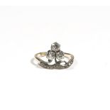An 18ct gold and diamond-set dress ring of trefoil design, claw-set with old mine-cut diamonds,