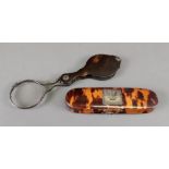 A magnifying glass, late 18th/early 19th century, in shaped tortoiseshell case,