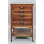 An Edwardian mahogany music cabinet, fitted with five fall front drawers, on square tapered legs,