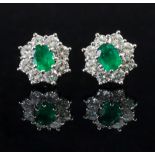 A pair of 18ct white gold emerald and di