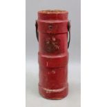 A cylindrical red canvas covered cartrid