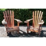 A pair of vintage stained slatted pine loggia armchairs.