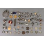 A collection of silver and other charms,