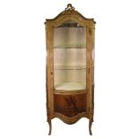 A reproduction Louis XV style rosewood gilt metal mounted vitrine, of serpentine outline,
